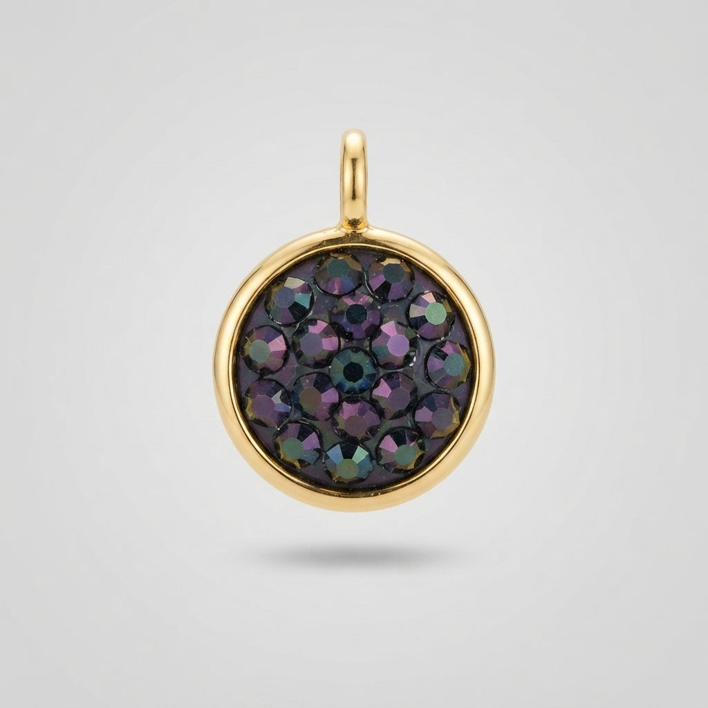 A round gold pendant charm featuring a pavé setting of faceted iridescent gemstones that shift between purple, green, and blue, set against a light gray background.