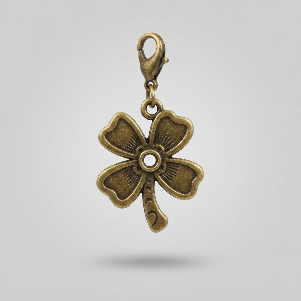 An antique bronze four-leaf clover charm with a lobster clasp, shown against a neutral light gray background.