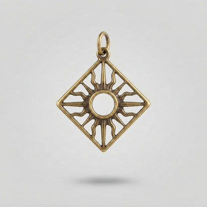 A square diamond-shaped pendant charm with a sunburst design, featuring an antique gold/bronze finish and a top loop, shown against a light gray background.